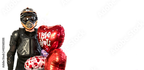 Happy Valentine's day! Mobile motorcyclist in a helmet with balloon heart for Valentine's Day