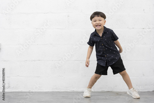 Studio shot portrait of happy little Asian boy on background © Keopaserth