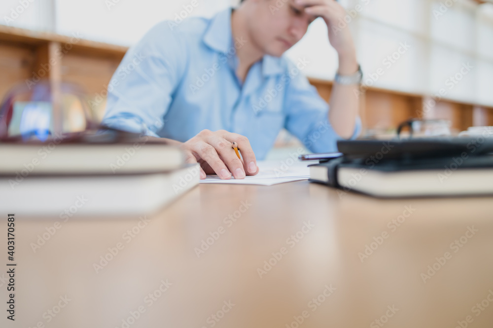 Tired businessman hold pencil at workplace in office and headache or angry. Overworking, making mistake, stress, termination, fail, bad, sad tired or depression concept Tired businessman hold pencil at workplace in office and headache or angry. Overworking, making mistake, stress, termination, fail, bad, sad tired or depression concept