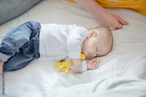 cute baby sleeping in bed at home. family love concept.