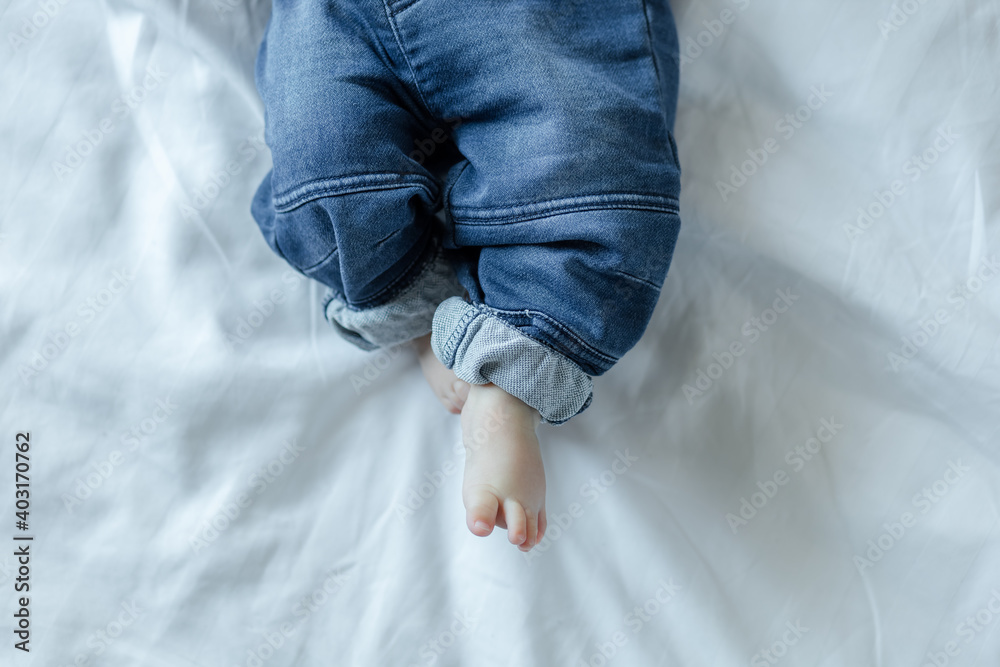 Baby feet on white bed background Baby feet on white bed background