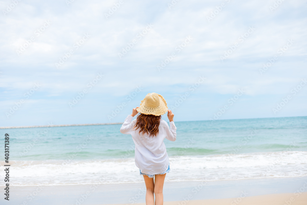 young woman wearing sun hat on the  beach. summer, holidays, vacation, travel concept