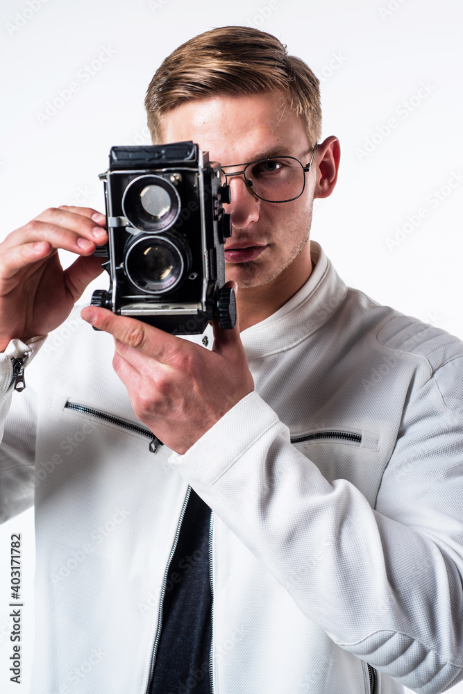 Young photographer take photograph looking in eye of retro camera isolated on white, session Young photographer take photograph looking in eye of retro camera isolated on white, session
