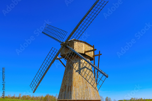 Small old mill on a background of blue sky.