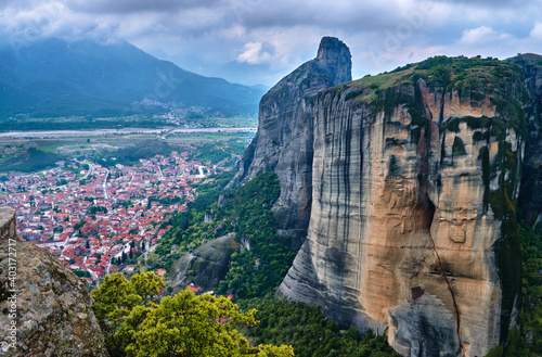 View from cliff top over Kalambaka and Kastraki villages at foot of Meteora mountains, Greece, and famous impressive pillars around it on cloudy day
