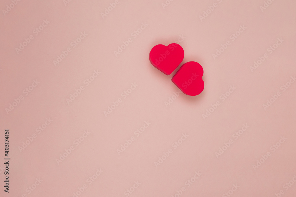  two red hearts on a pink background