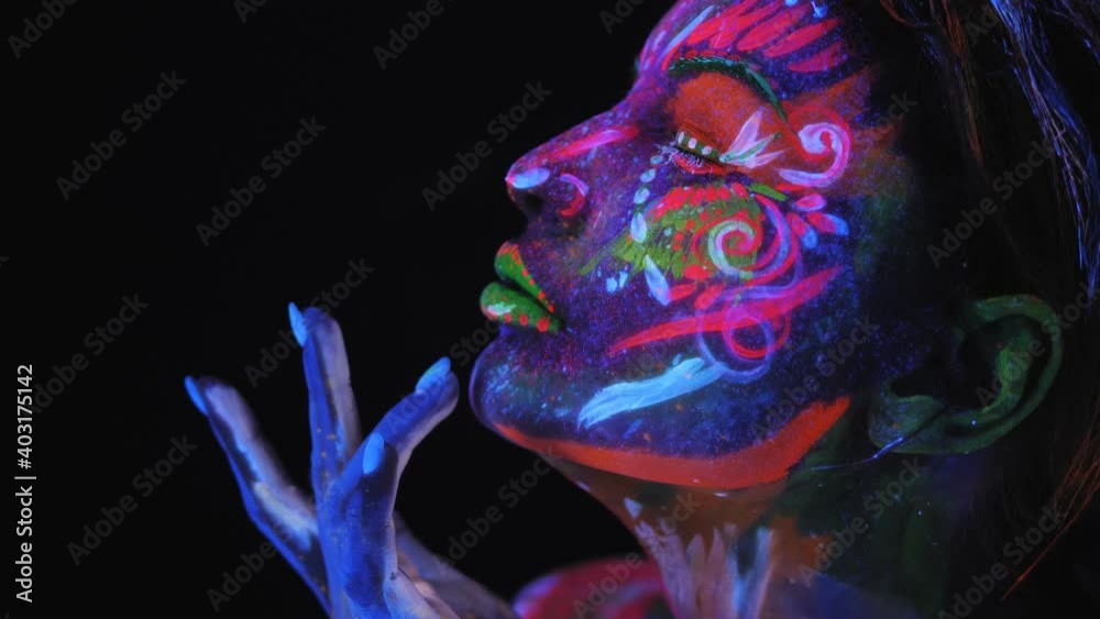 Portrait of girl with a UV pattern on her face. Graceful model posing with UV pattern on body. Portrait of girl with a UV pattern on her face. Graceful model posing with UV pattern on body.