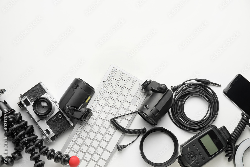 Computer keyboard and modern photographer's equipment on white background