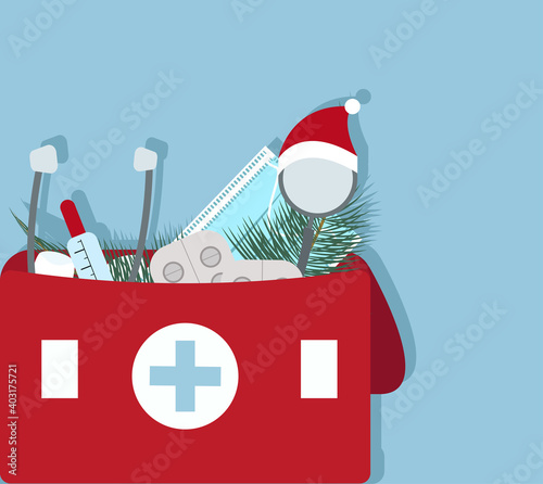 Christmas First aid kit with medicines in a red bag on a blue background. Pharmacist holding. Healthcare and medical treatment concept. a bag with pharmacy drug in bottle and box for disease treatment
