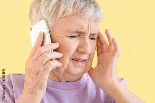 Stressed senior woman talki...