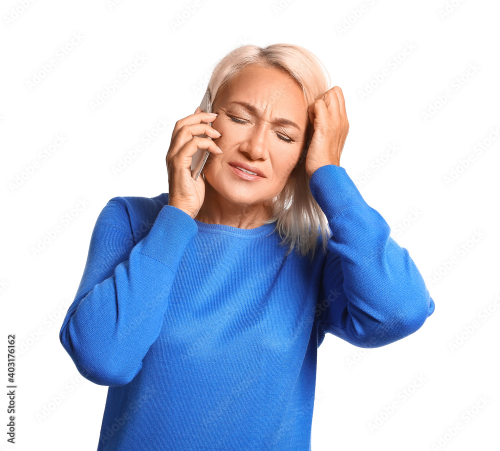 Stressed mature woman talking by mobile phone isolated on white background Stressed mature woman talking by mobile phone isolated on white background