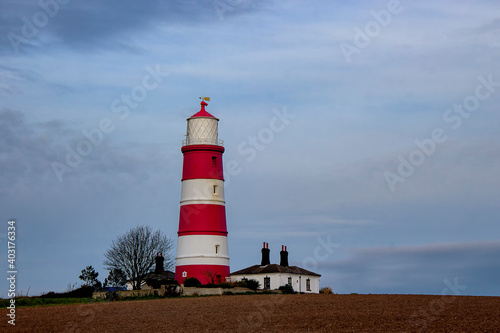 Happisburgh Lighthouse on the top of a hill on the coast of Norfolk  UK