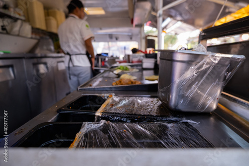 Cook preparing vegetarian meal inside a food truck