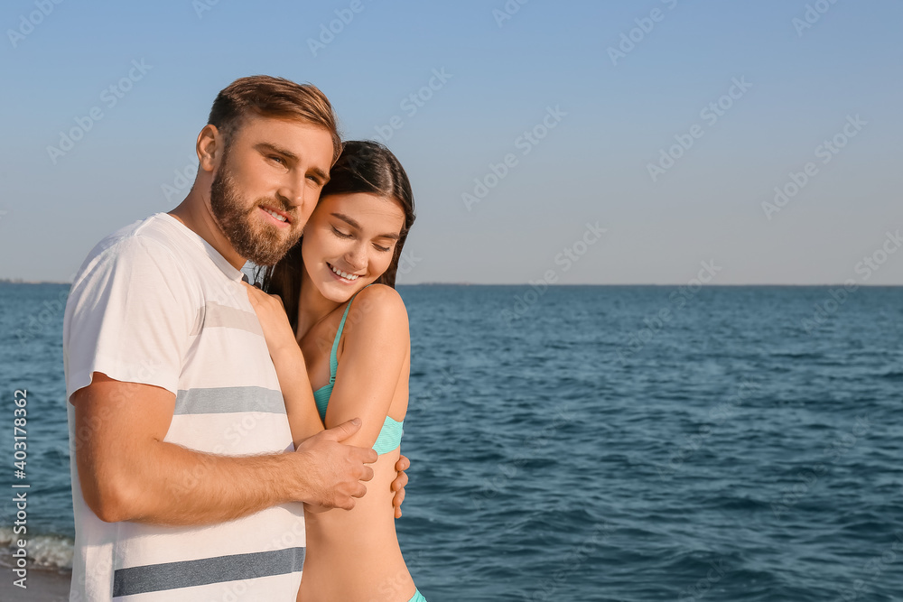 Happy young couple on sea beach Happy young couple on sea beach