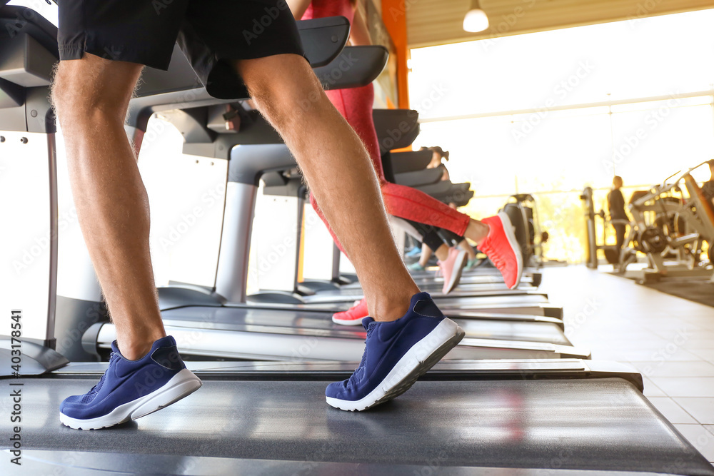 People training on treadmills in gym