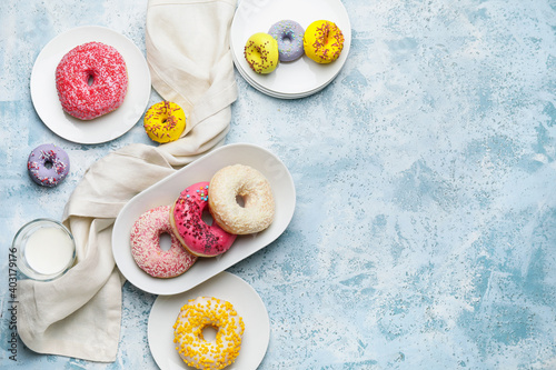 Composition with sweet donuts on color background