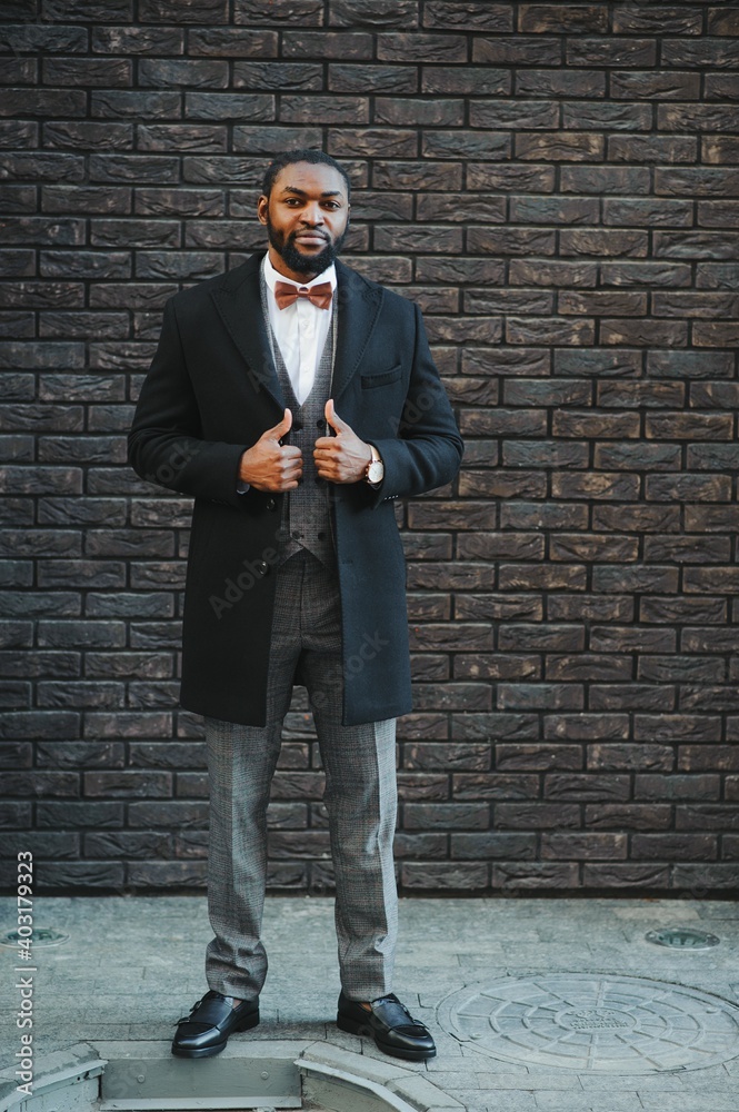 Portrait of an African American businessman wearing a suit standing in an outdoor business environment Portrait of an African American businessman wearing a suit standing in an outdoor business environment
