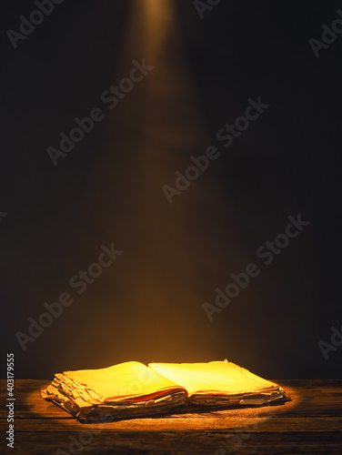 Open book on table against ...