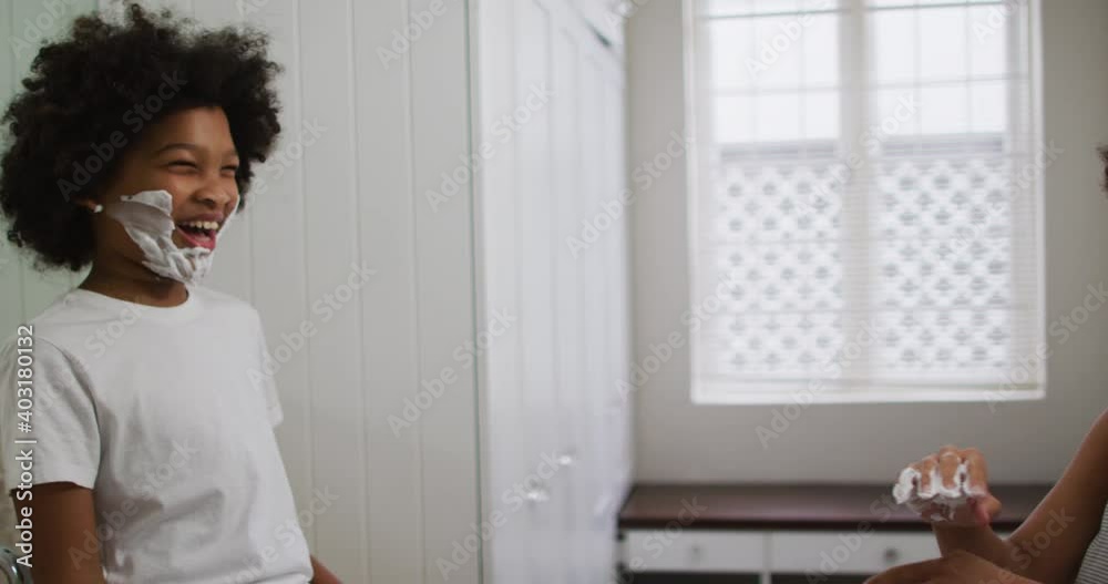 Mixed race mother and daughter having fun in bathroom Mixed race mother and daughter having fun in bathroom