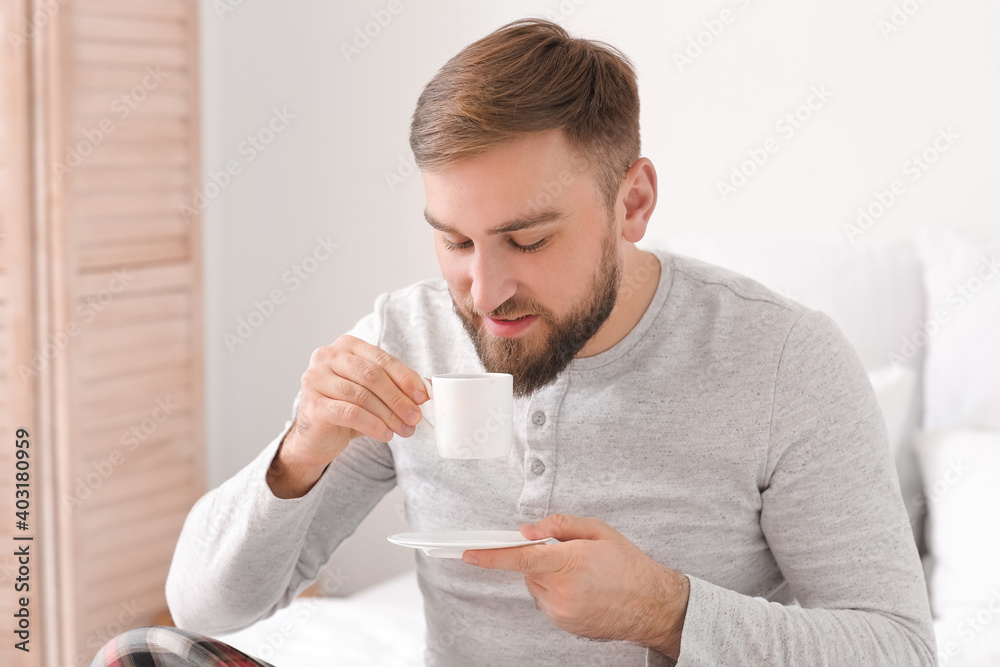 Morning of young man drinking hot coffee in bed Morning of young man drinking hot coffee in bed