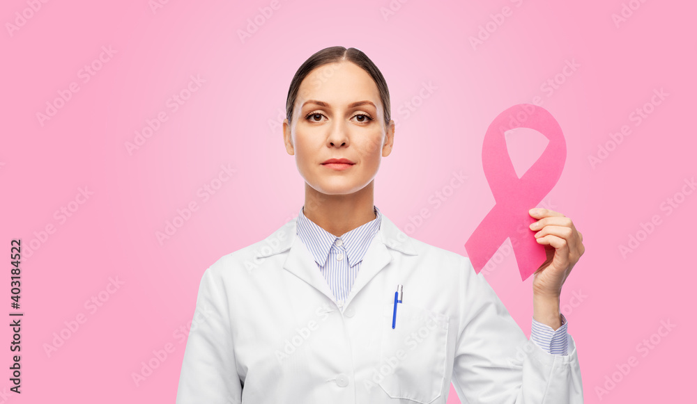 medicine, healthcare and oncology concept - female doctor in white coat with pink breast cancer awareness ribbon medicine, healthcare and oncology concept - female doctor in white coat with pink breast cancer awareness ribbon