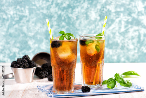 The glass of iced tea on wooden table. Cuba Libre or long island cocktail