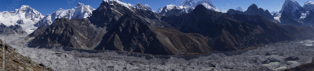 Panorama of Ngozumpa glacier (longest Himalayan glacier) with Everest, cho la, and lobuche in the background. Stone covered glacier. 