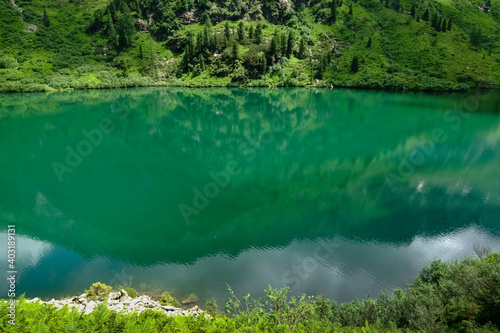 green water with reflection from a mountain while hiking