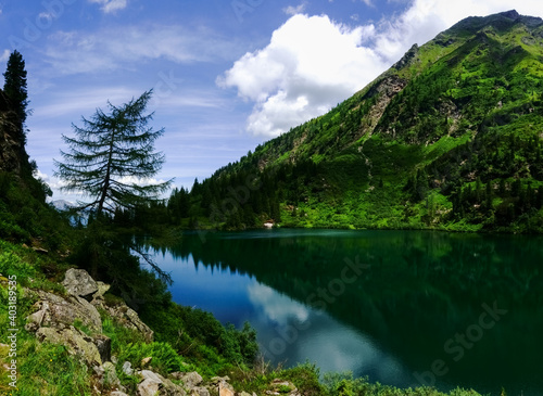 mountain lake between mountains with trees and rocks