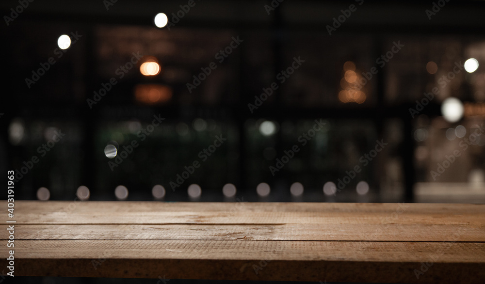 blurred cafe with empty wooden table for your product or montage