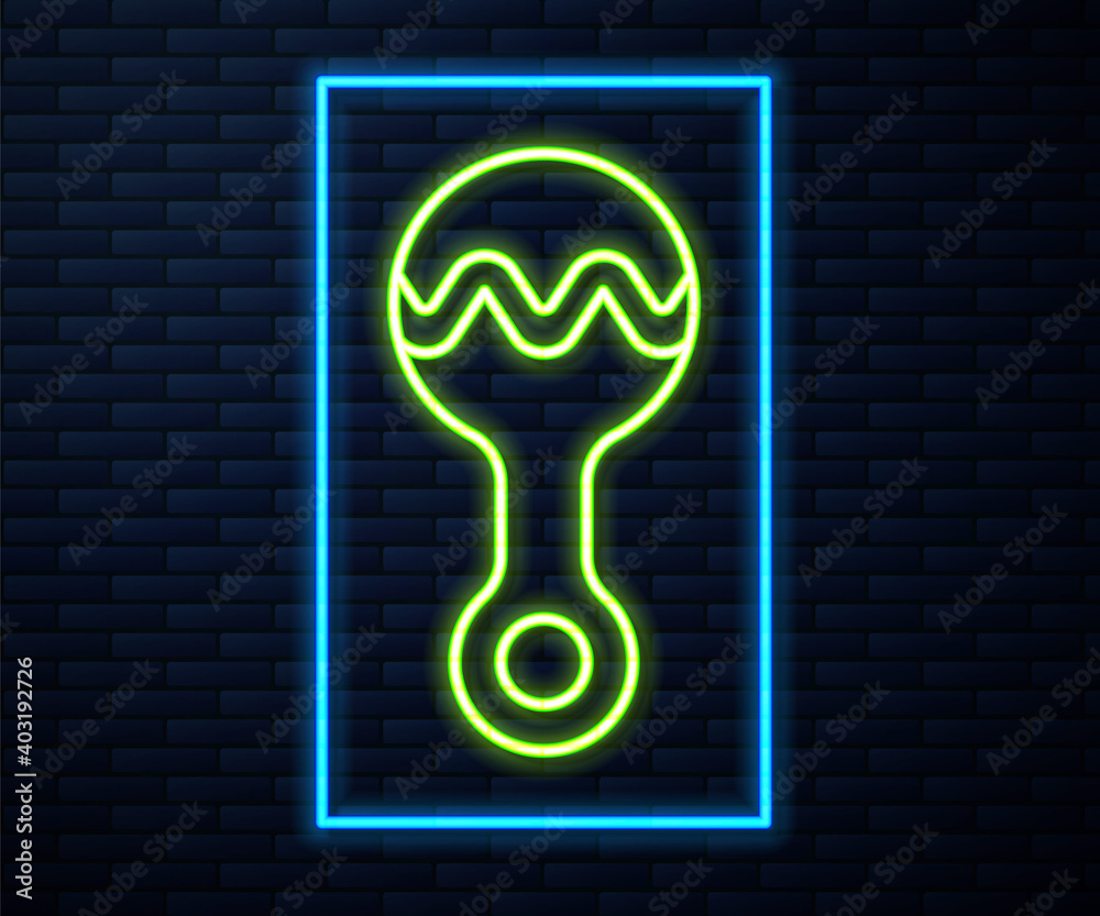 Glowing neon line Rattle baby toy icon isolated on brick wall background. Beanbag sign. Vector.