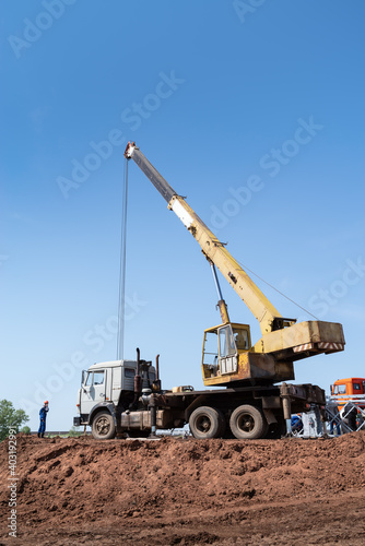 Truck crane at a construction site. The picture was taken in the summer in Russia