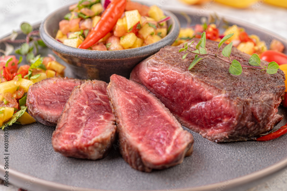Fried beef steak with peach fruit salsa, tomato and chili. Fried beef steak with peach fruit salsa, tomato and chili.