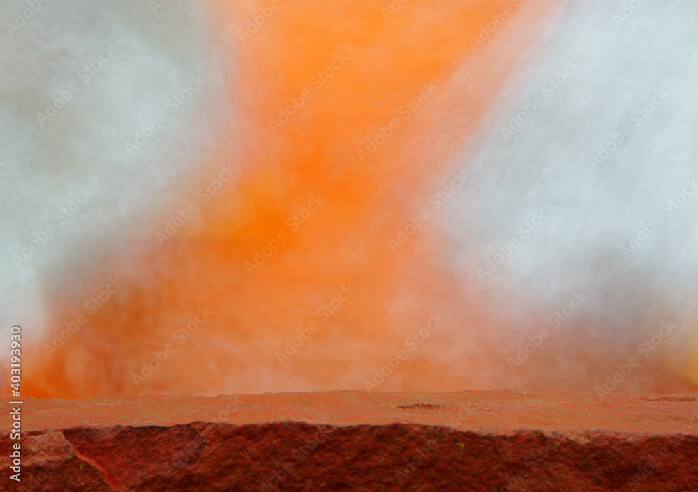 Obraz premium An Orange Rock Shelf for a Product Display, Showing a Shallow Depth to the Top Middle Ledge, with a Blurred Foreground and Background.
