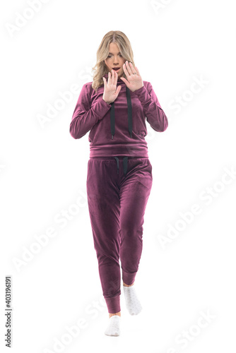 Screaming scared young pretty woman in casual home clothes looking down terrified. Full body length isolated on white background. photo