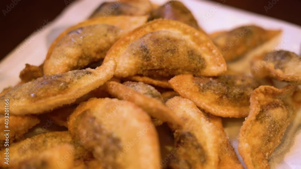 Fried gyoza dumplings with mushroom filling. Golden color hot crunchy dumplings cooked in a pan. Fried gyoza dumplings with mushroom filling. Golden color hot crunchy dumplings cooked in a pan.