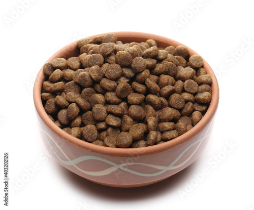 Dog food, dry round granules for pets in bowl isolated on white background