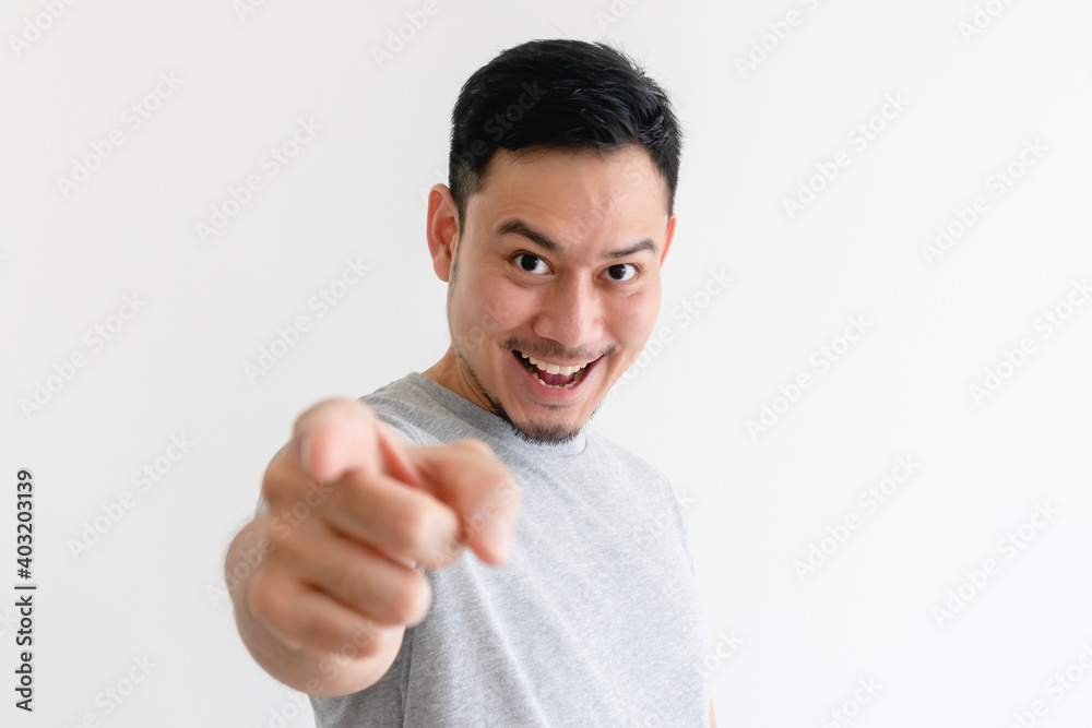 Asian man is pointing into the camera with an excited facial expression. Asian man is pointing into the camera with an excited facial expression.