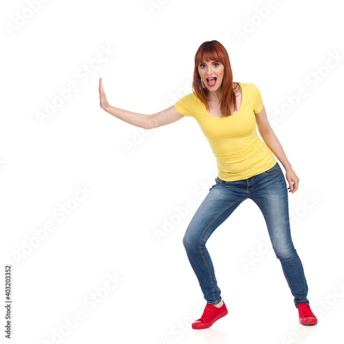 Excited Young Woman Pushing Something With One Hand