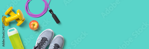 Fitness equipment on a turquoise background with copyspace