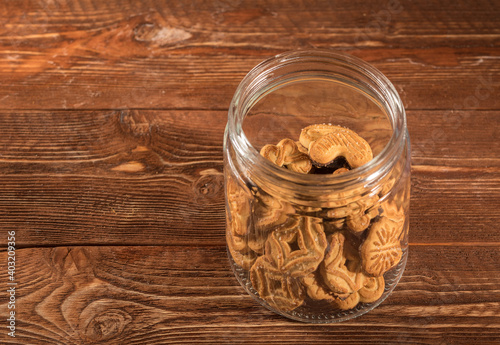 glass jar with biscuits on a wooden surface