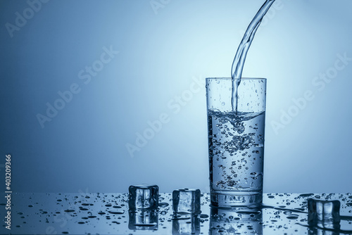 Pure drinking water is poured into a clear glass.