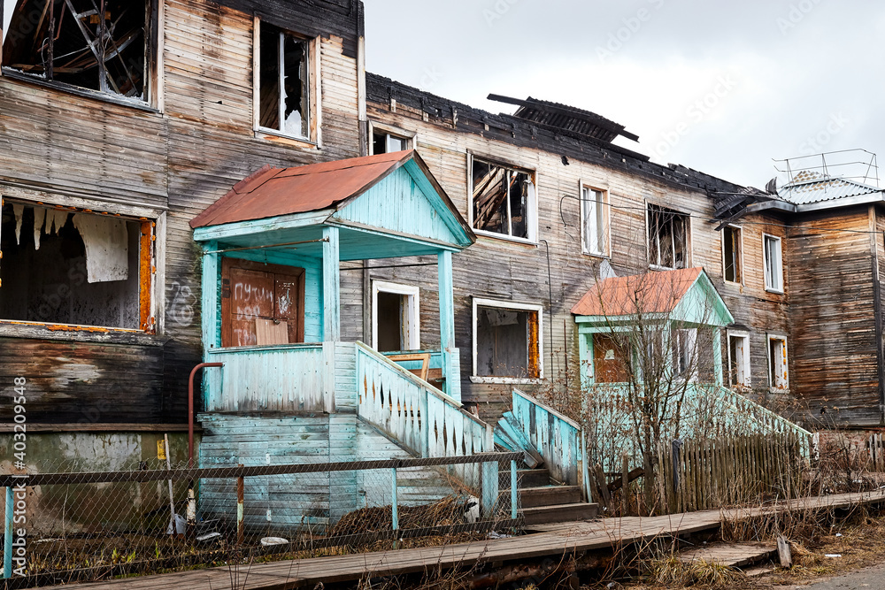 Kirov, Russia - April 18, 2020: Old poor charred after a fire house on the street of a small village or city in Russia.