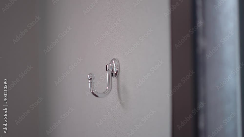 Repair service technician man hand using electric screwdriver to fasten metal screw holding blinds hook on wall. Repair service technician man hand using electric screwdriver to fasten metal screw holding blinds hook on wall.