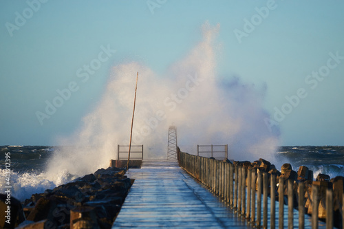 Dramatic, strong waves and foam spray hit the pier in Vorupoer during storm on the North Sea coast of Denmark     © lavrsen