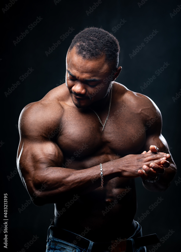 Portrait of a bodybuilder african american in studio. Naked torso of an athlete. Strong muscules. Portrait of a bodybuilder african american in studio. Naked torso of an athlete. Strong muscules.