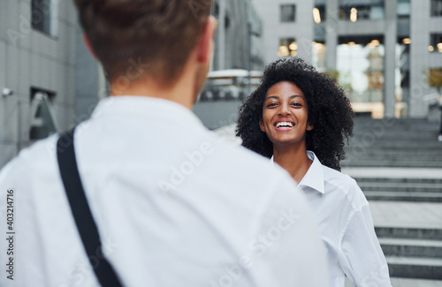 Nice meet. Man with afrian american woman together in the city outdoors photo