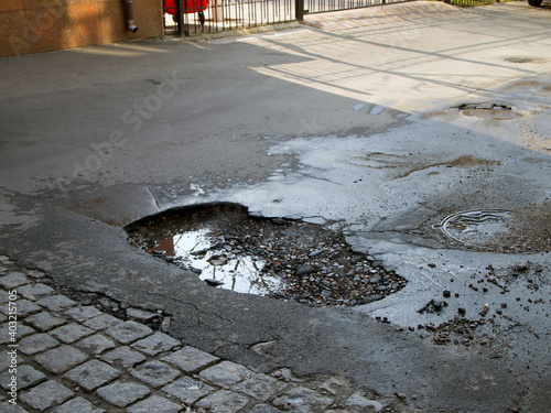 Vászonkép A huge pothole in the street road