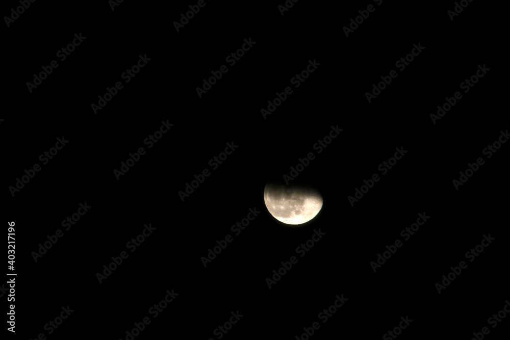 Moon behind the clouds at night Moon behind the clouds at night