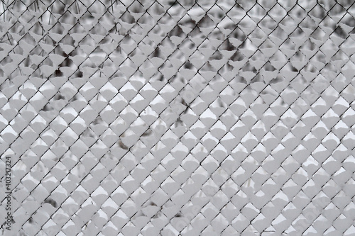 Snow-covered wire fence